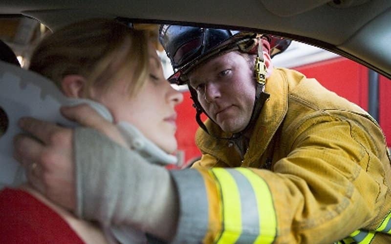 firefighter helping injured woman neck