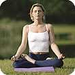girl meditating or doing yoga in park on yoga mat