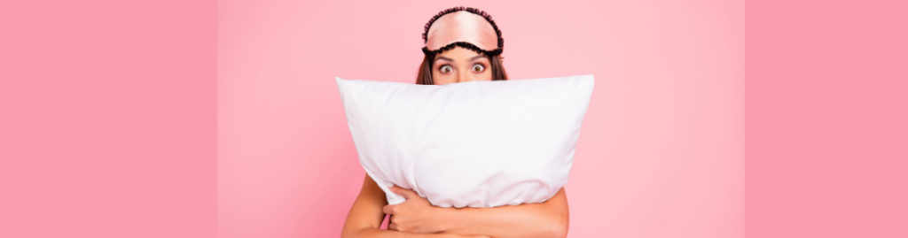 woman with facemask holding a pillow