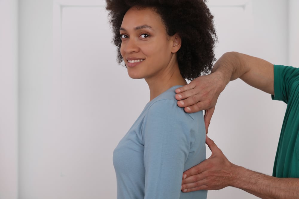 Woman having chiropractic back adjustment.
