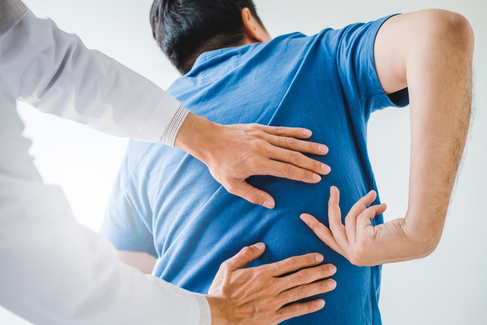 Physical Doctor consulting with patient about Back problems
